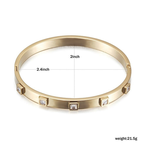 Gold bracelet with diamond accents and measurements on a white background