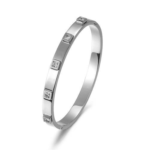 Silver bracelet with embedded diamonds on a white background