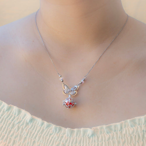 White butterfly aroma necklace by Amrita Court, a stylish essential oil diffuser pendant for on-the-go aromatherapy.